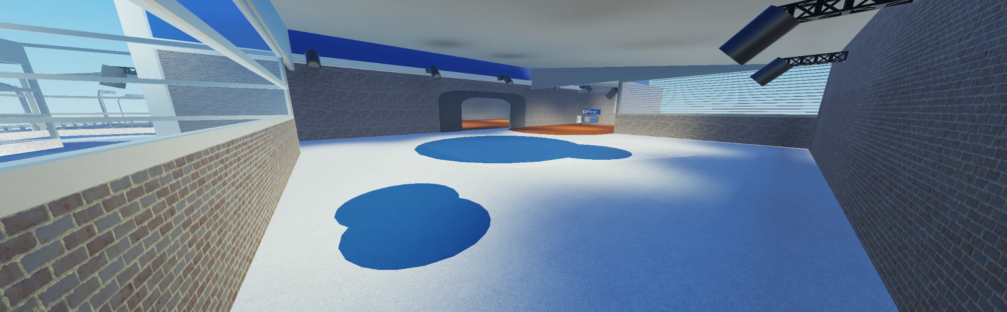 A long open hall with blue carpet patches on a white floor, leading to an archway and an Office sign.